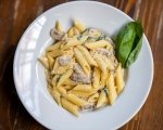 Creamy suya-infused penne pasta with chicken, peppers and onions.